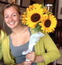 Intern holding sunflowers